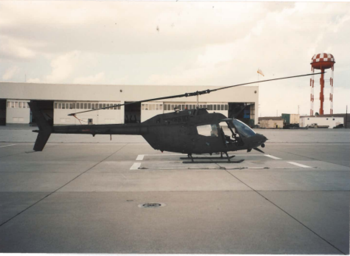 A large Helicopter on a landing pad