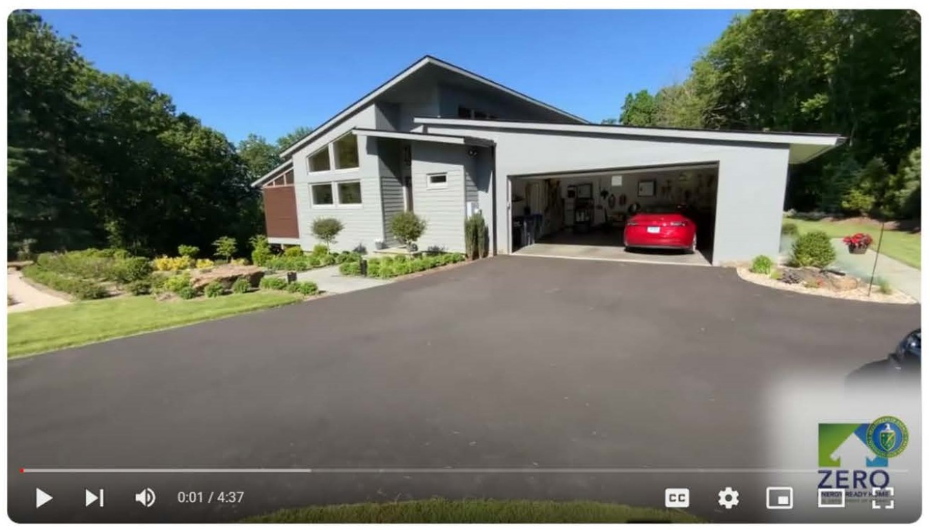 Screenshot of the beginning of the video: a view of the exterior of a house and driveway, with a car in the garage.