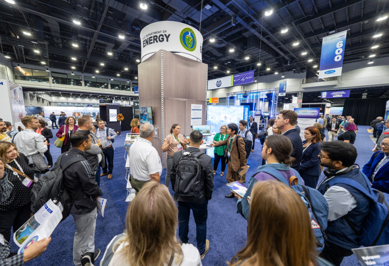 People at the DOE booth at Clean Currents 2023