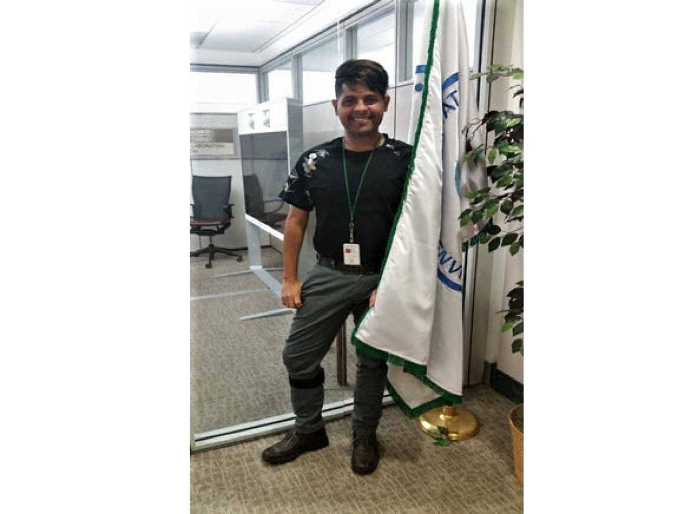 Jose Santiago Roque posing with a flag