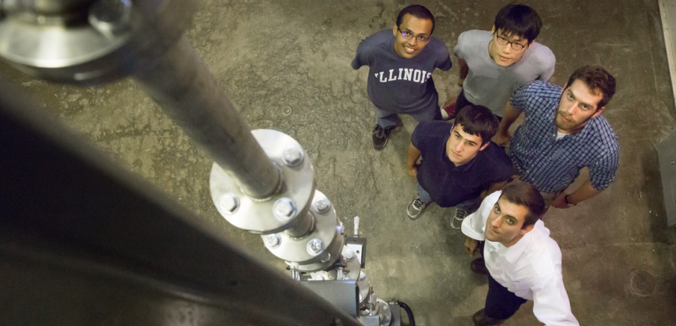 Professor Caleb Brooks and four other young men looking up into a camera above them