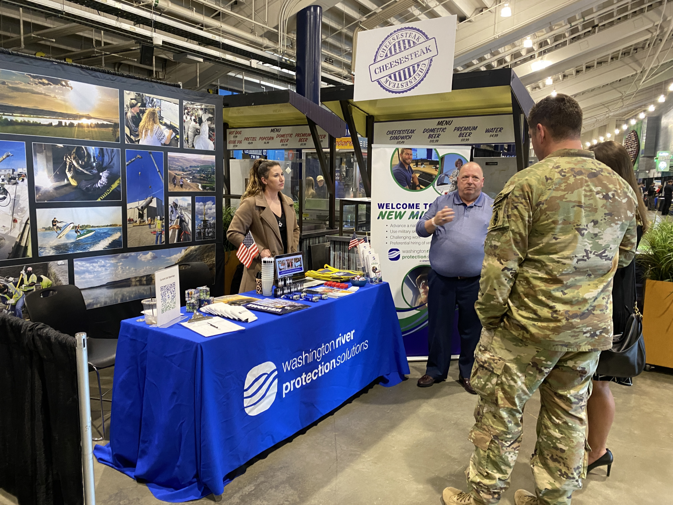 A table at a recruiting event for WRPS while an employee speaks to a veteran