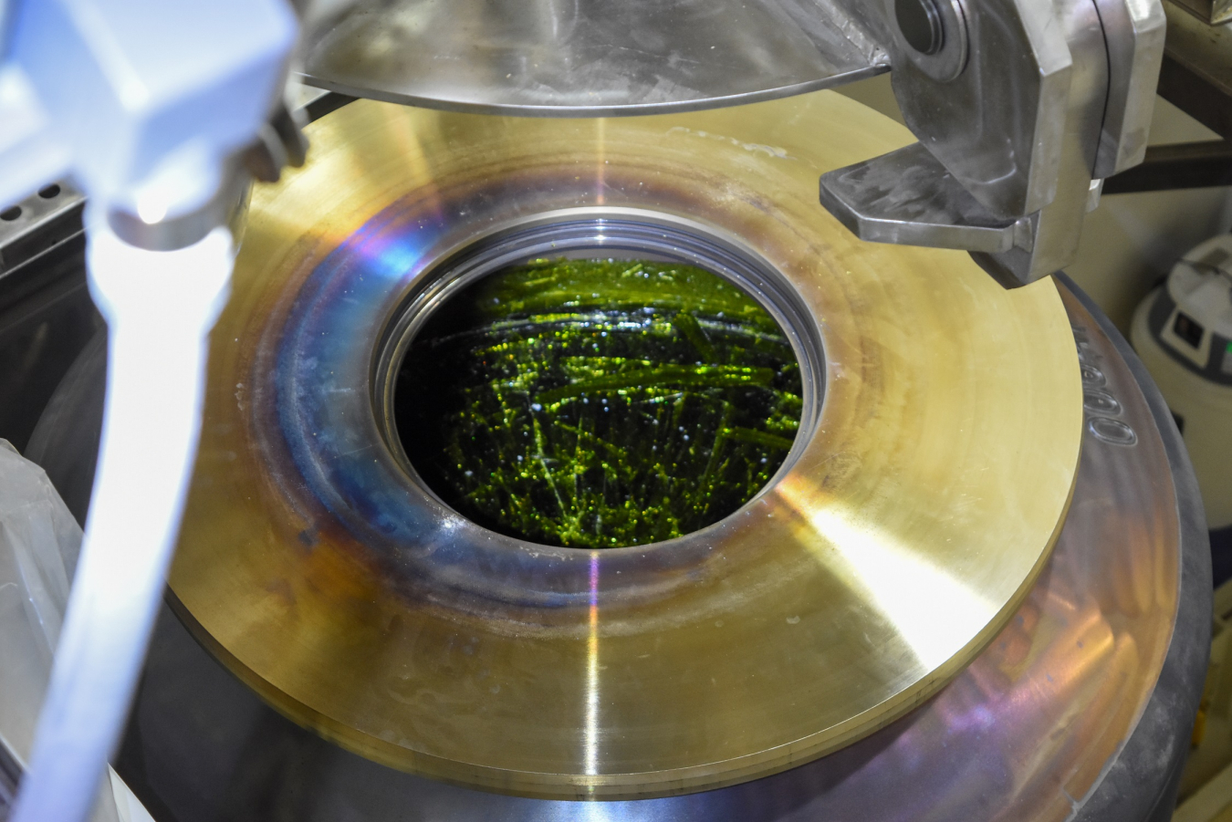 Photo of metal canister filled with green substance. 