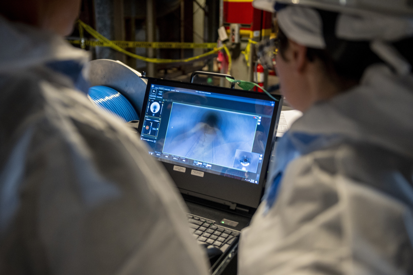 A computer with 2 employees watching a video on the screen