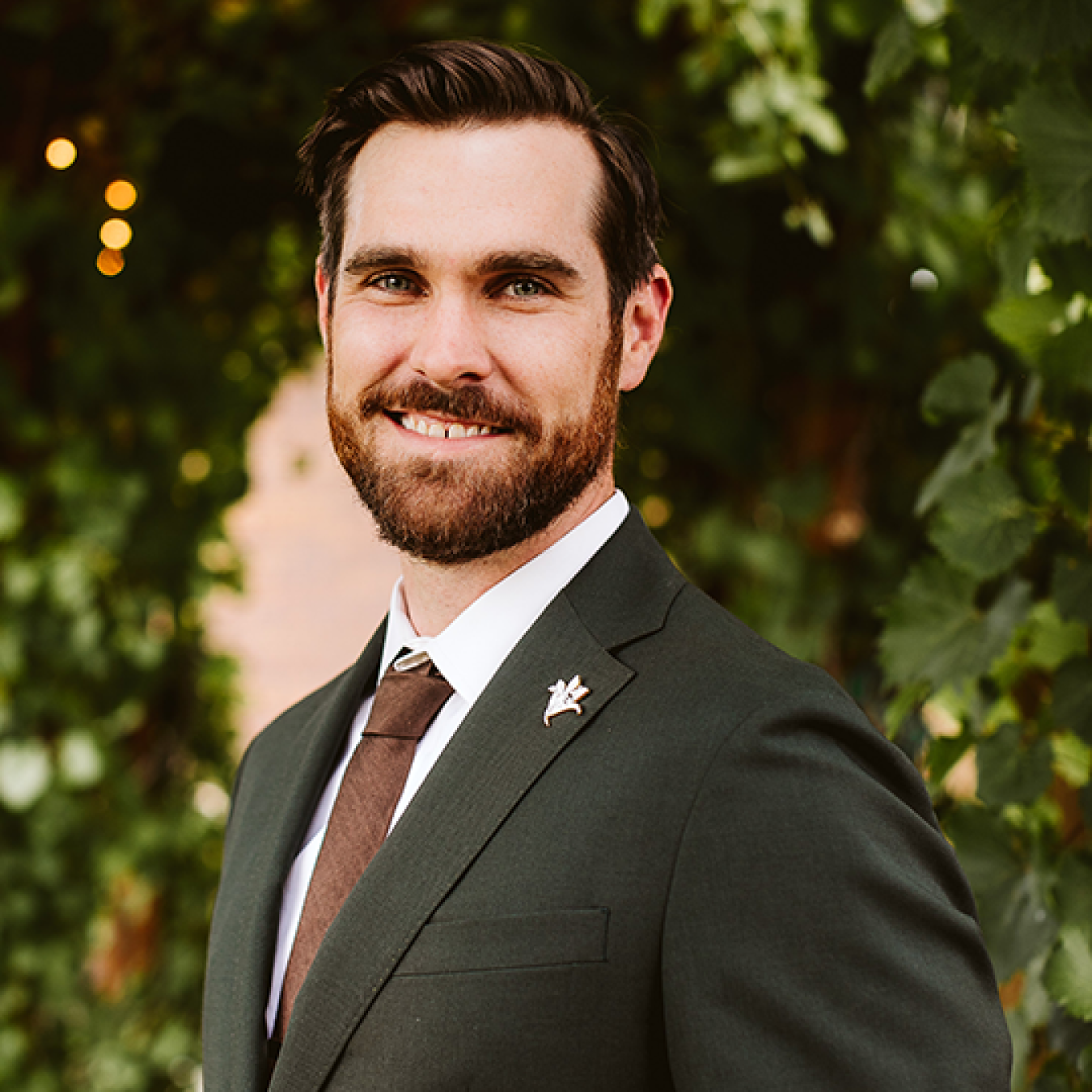 James W. Vickers smiling, wearing a suit and tie.