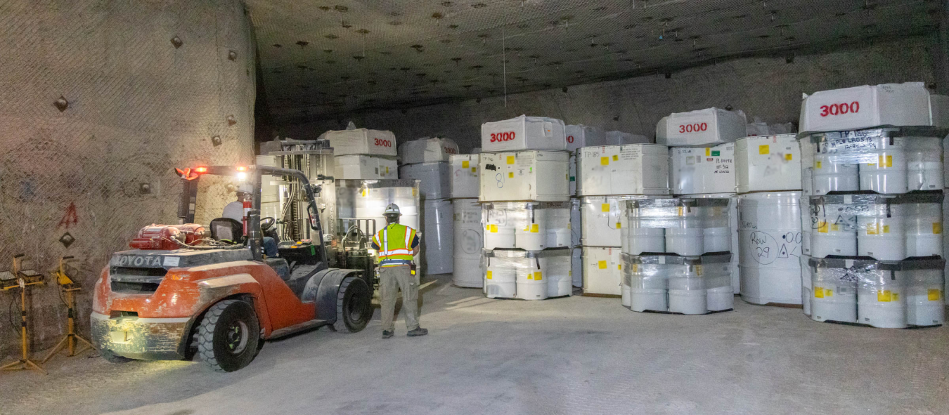 Large room with white square containers and a machine vehicle