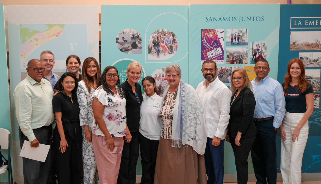 Secretary Jennifer Granholm poses for a photo with P.E.C.E.S and community representatives in Punta Santiago community of Humacao, Puerto Rico