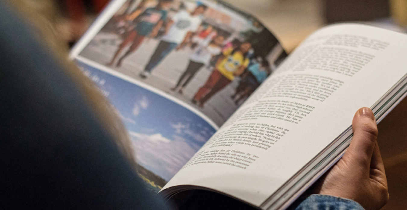 A person looking at a printed magazine