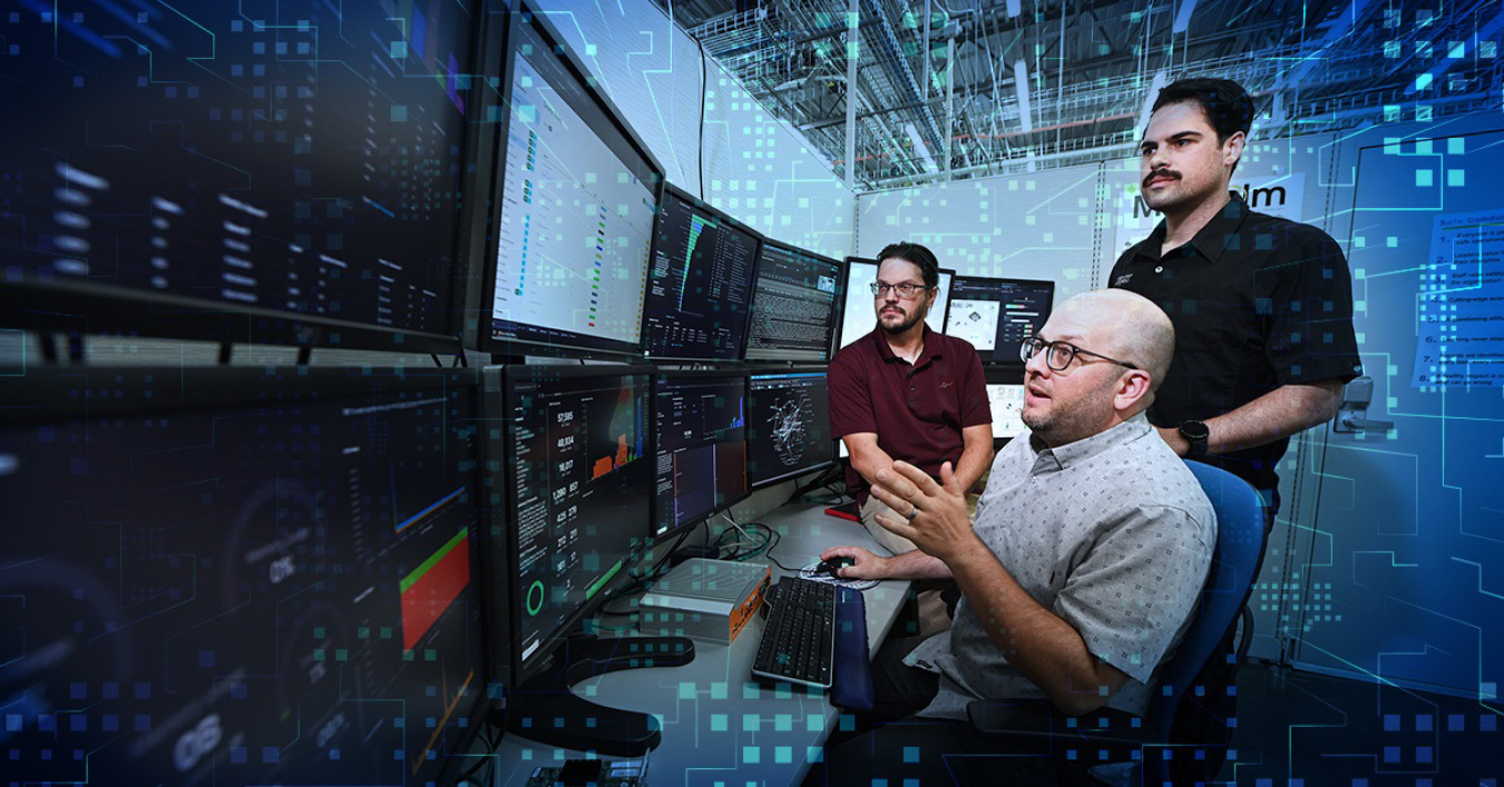 A group of data scientists sitting around computers at one of INL’s security operations test ranges analyzing information from the Malcolm framework