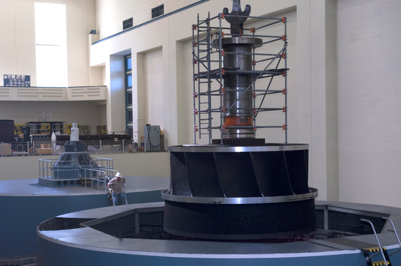 A hydropower turbine being lifted for rehabilitation 