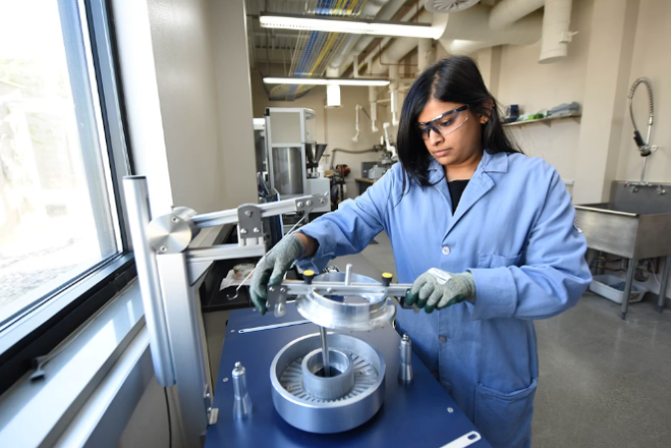 A researcher works on a ring shear tester in the lab. Photo from Idaho National Laboratory.