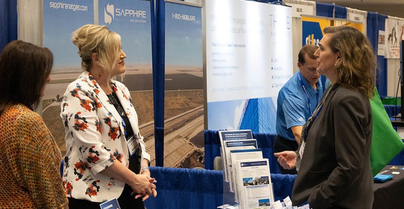 Two people at a DOE exhibit at a convention