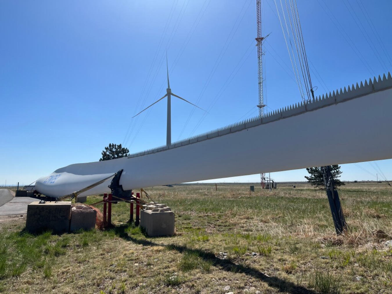 Close-up view of a wind turbine with serrated edges. 