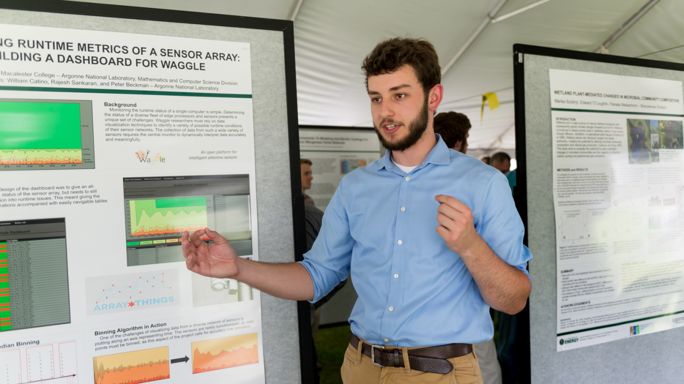 Zachary Skluzacek facing the camera, discussing his research poster