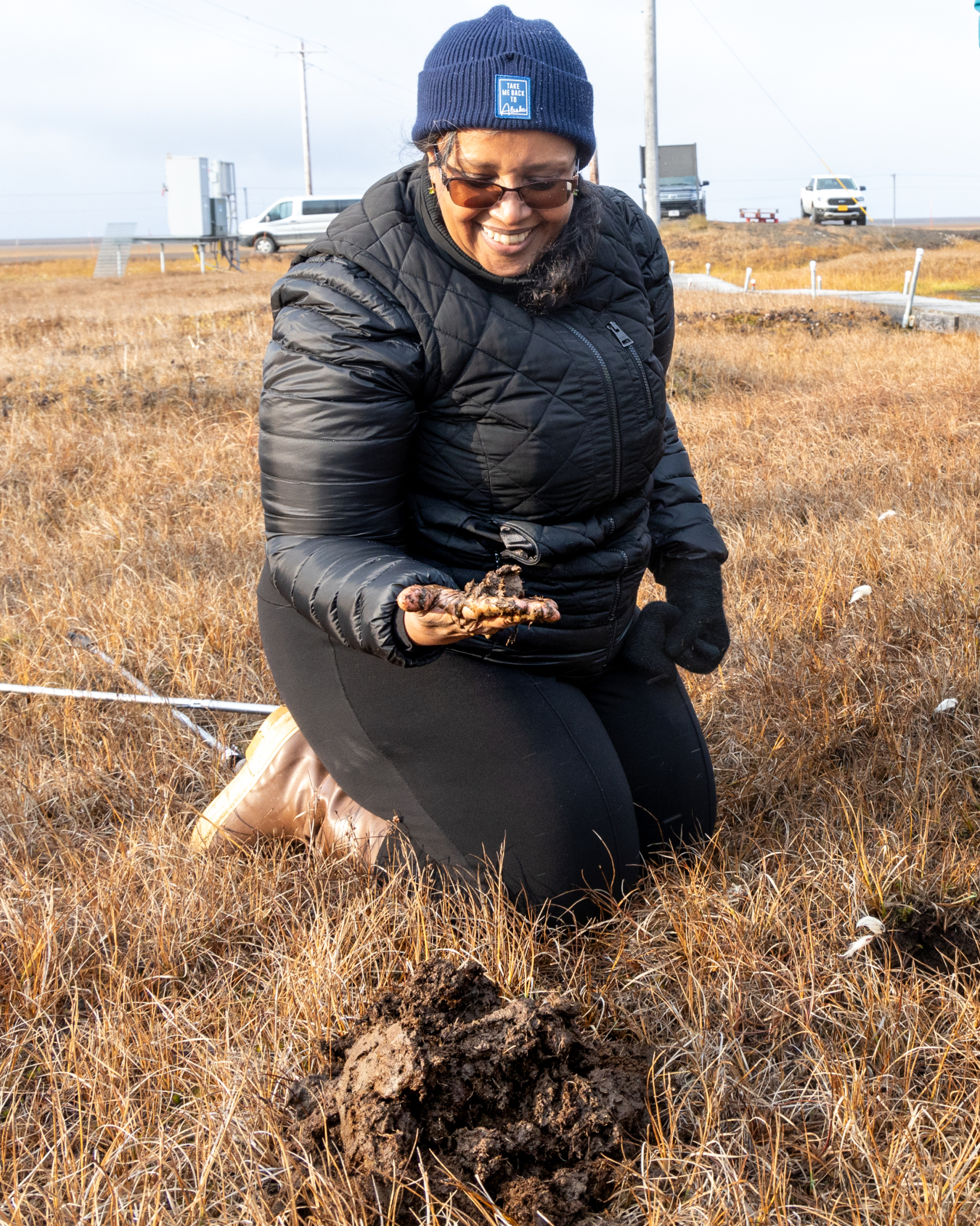 Dr. Berhe examines a soil sample in Utqiagvik, AK. 