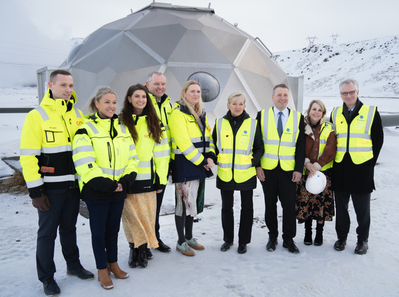 U.S. Energy Secretary Jennifer Granholm, Icelandic Minister Guðlaugur Þór Þórðarson, Ambassador to Iceland Carrin F. Patman, and Icelandic energy leaders and dignitaries stand in front of a geodesic dome that houses a borehole to transport geothermal energy.