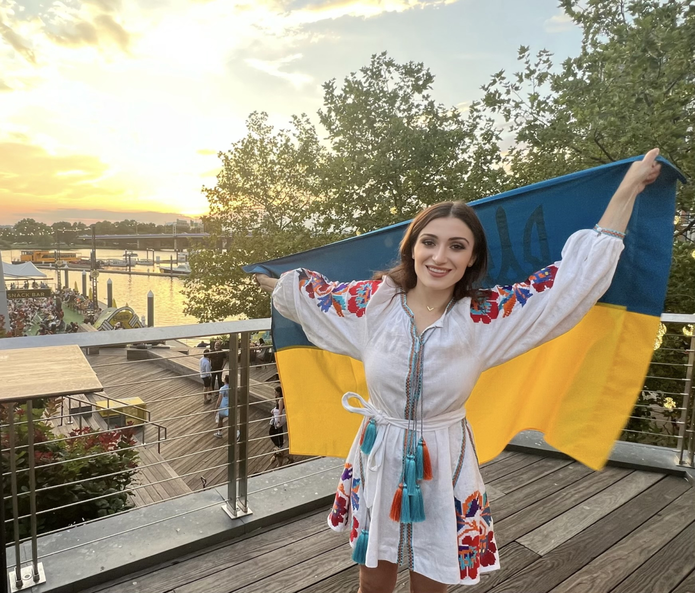 A portrait of Valerie Brusilovsky holding a Ukraine flag.