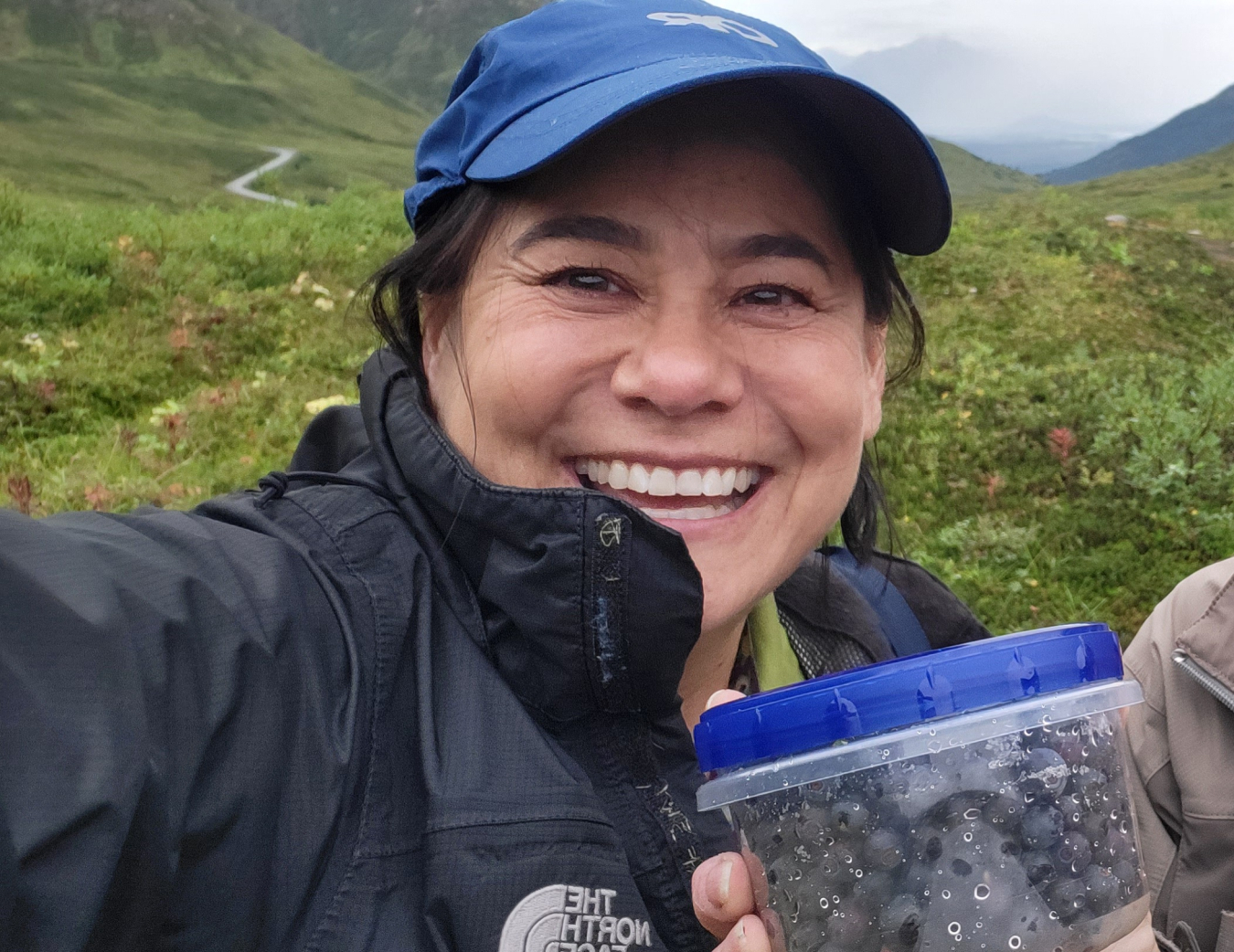 Annette Hard in Hatcher Pass, Alaska with foraged blueberries.