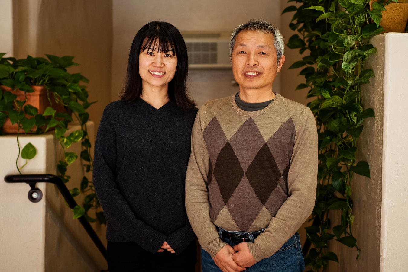 Two people pose and smile for the camera.