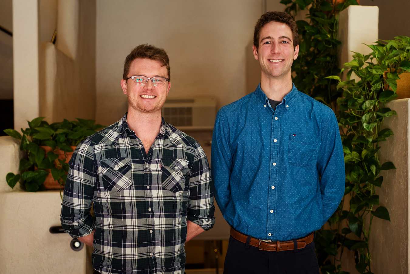 Two people pose and smile for the camera.