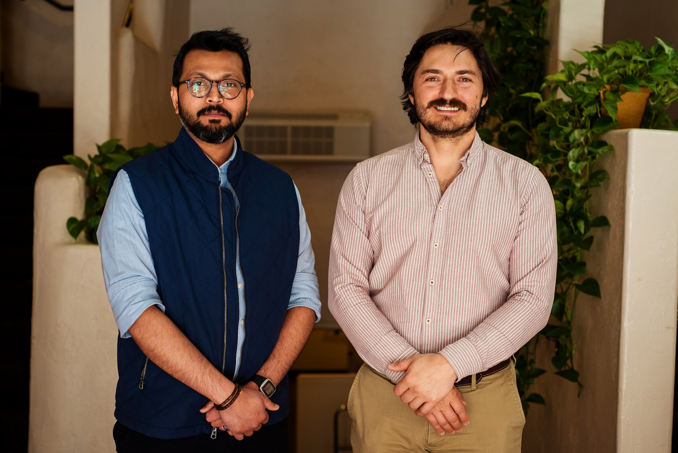 Two people pose and smile for the camera.