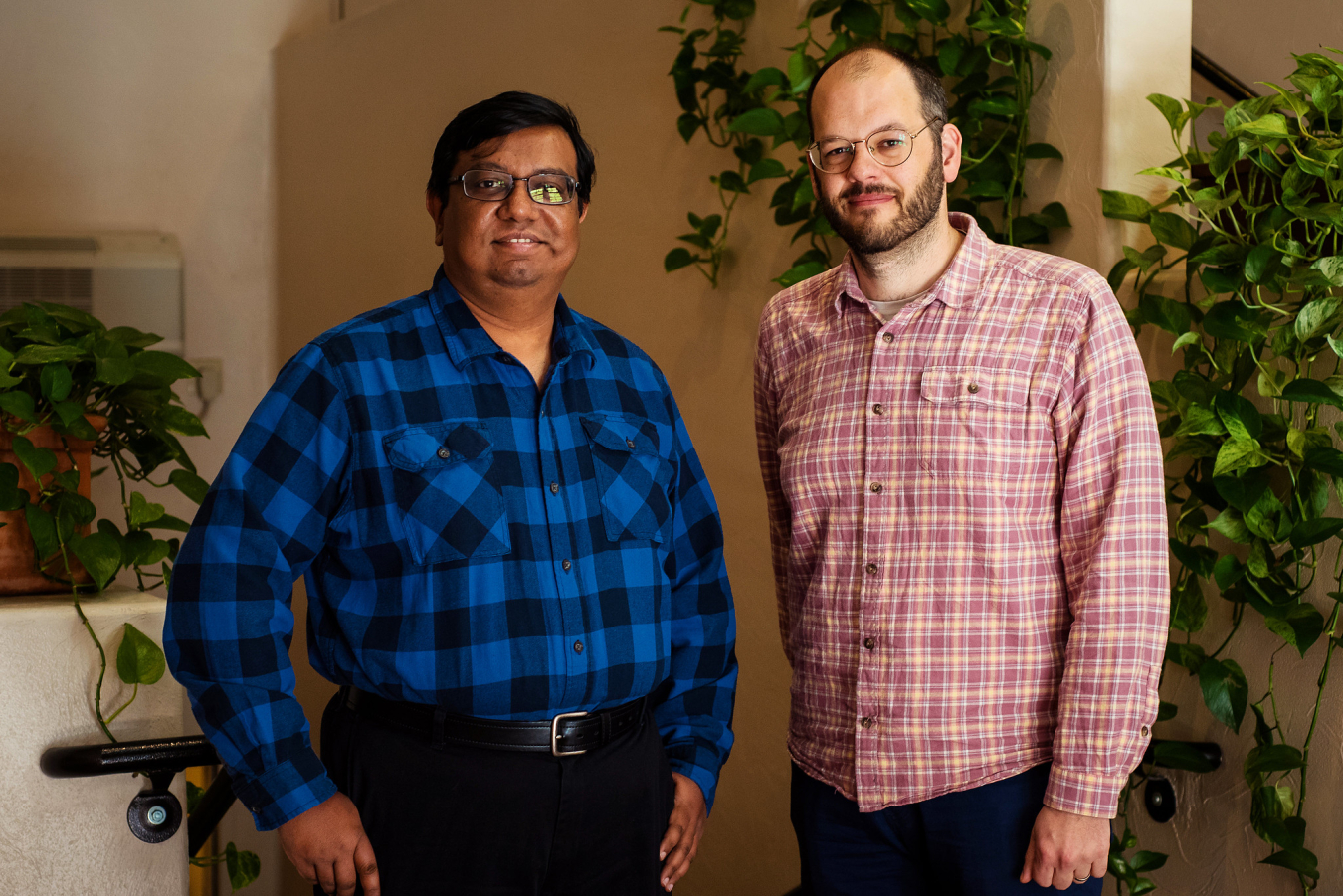 Two people pose and smile for the camera.