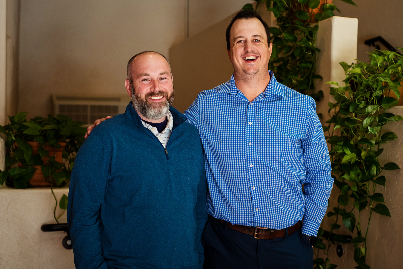 Two people pose and smile for the camera.