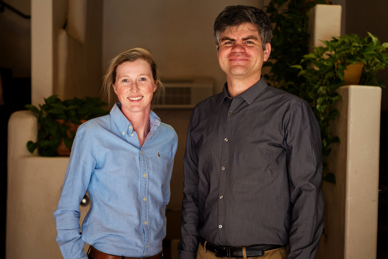 Two people pose and smile for the camera.