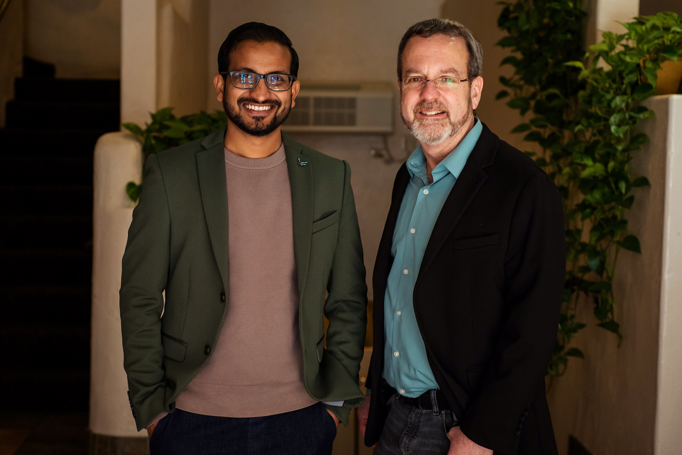 Two people pose and smile for the camera.