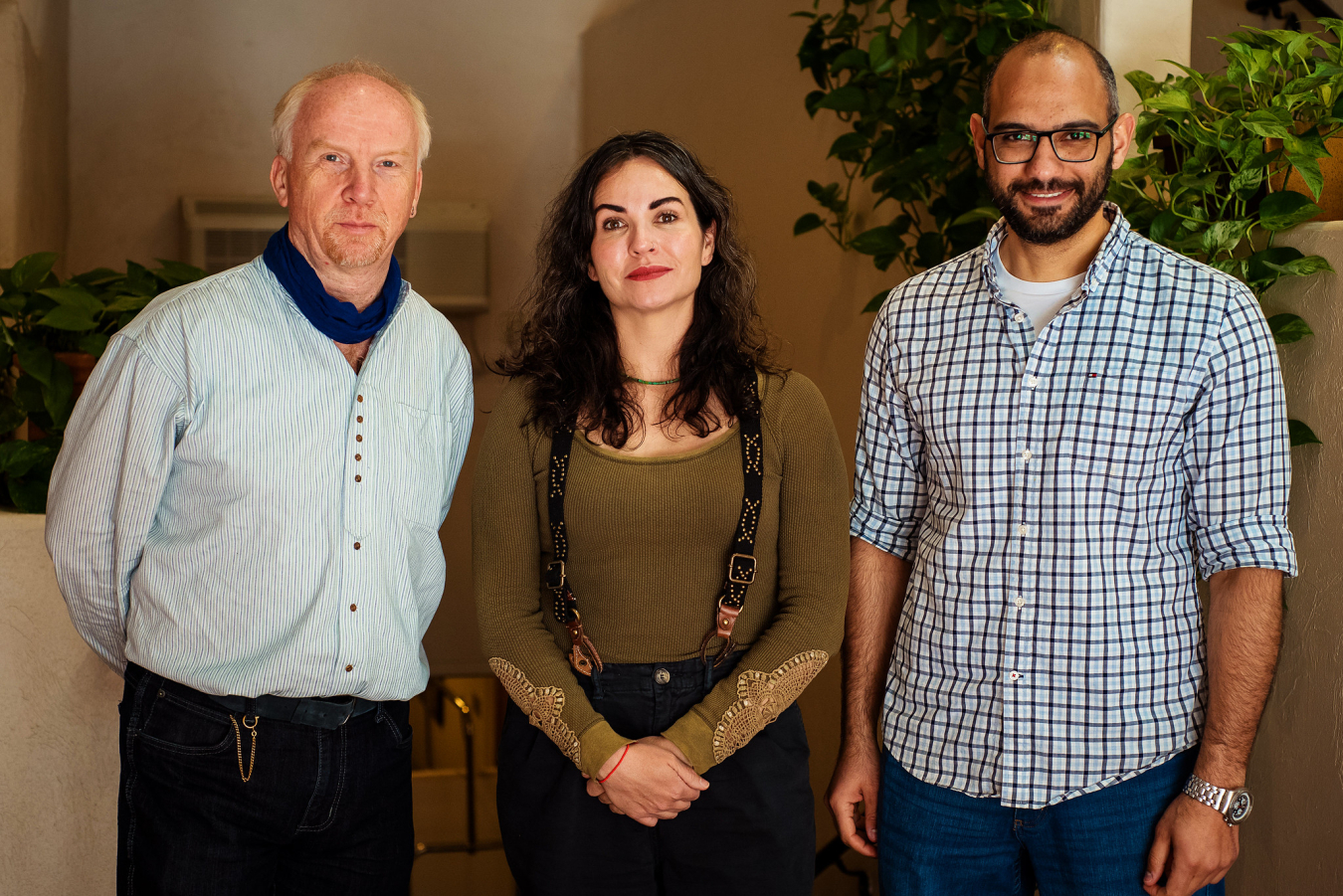 Three people pose and smile for the camera.