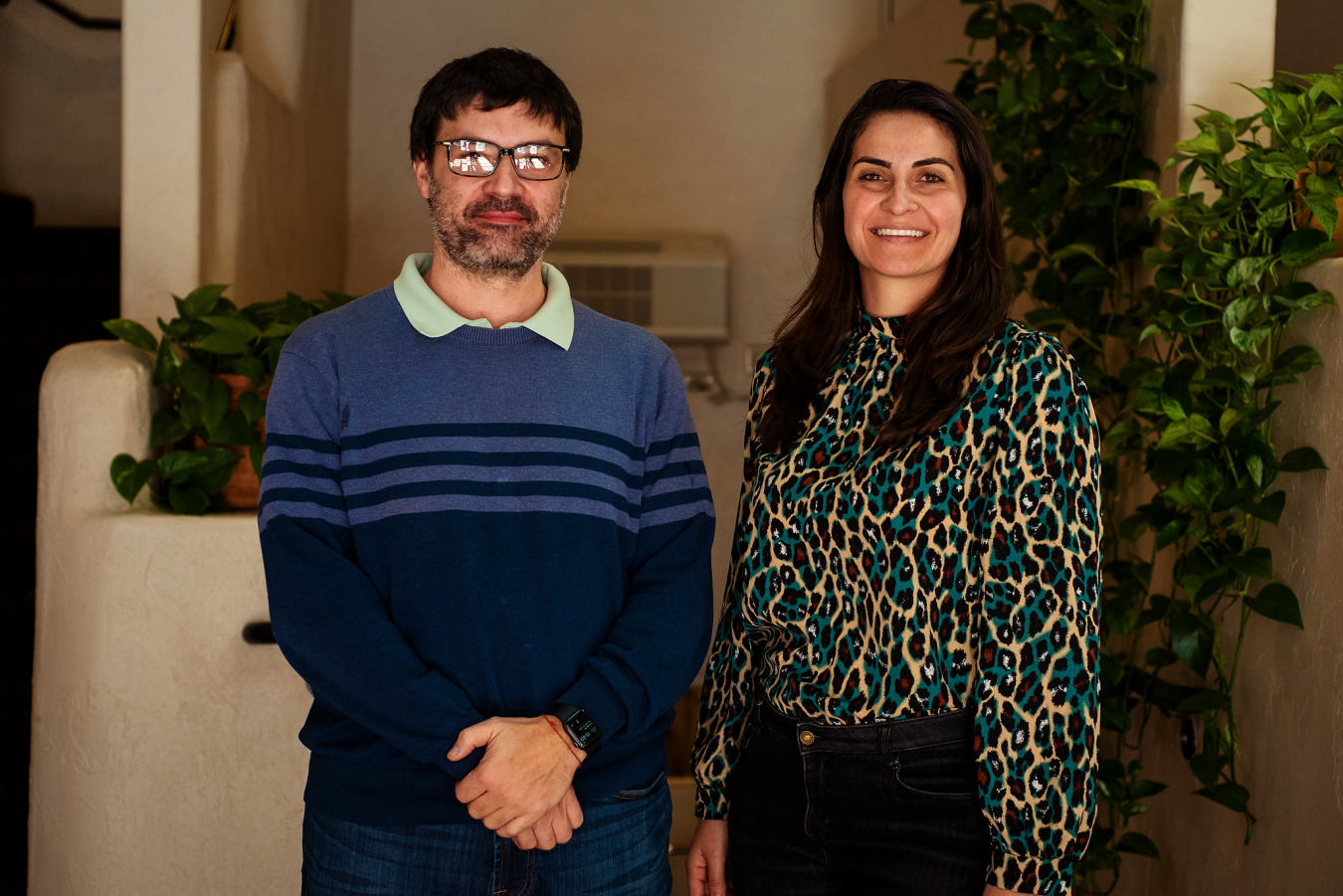 Two people pose and smile for the camera.