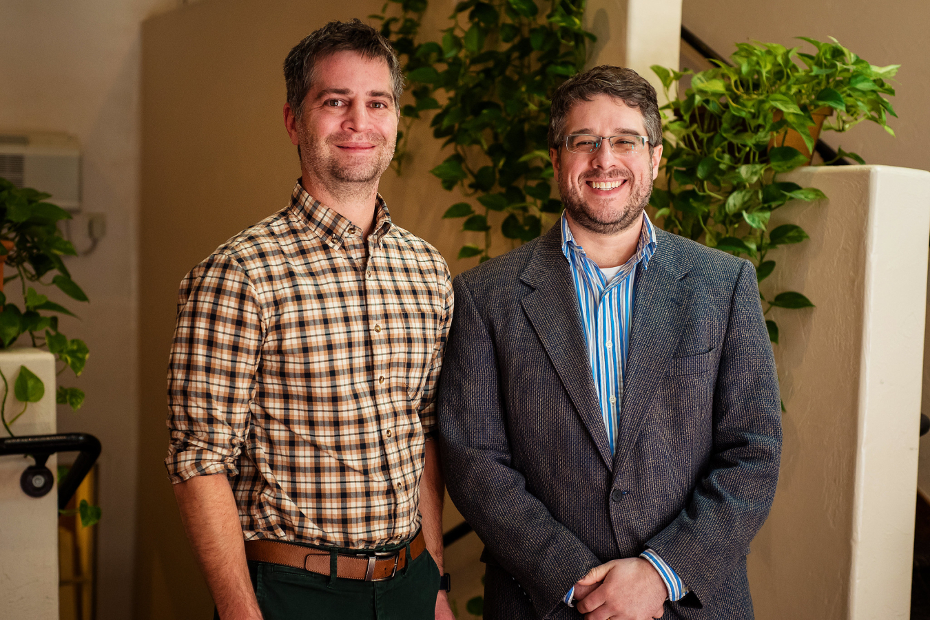 Two people pose and smile for the camera.