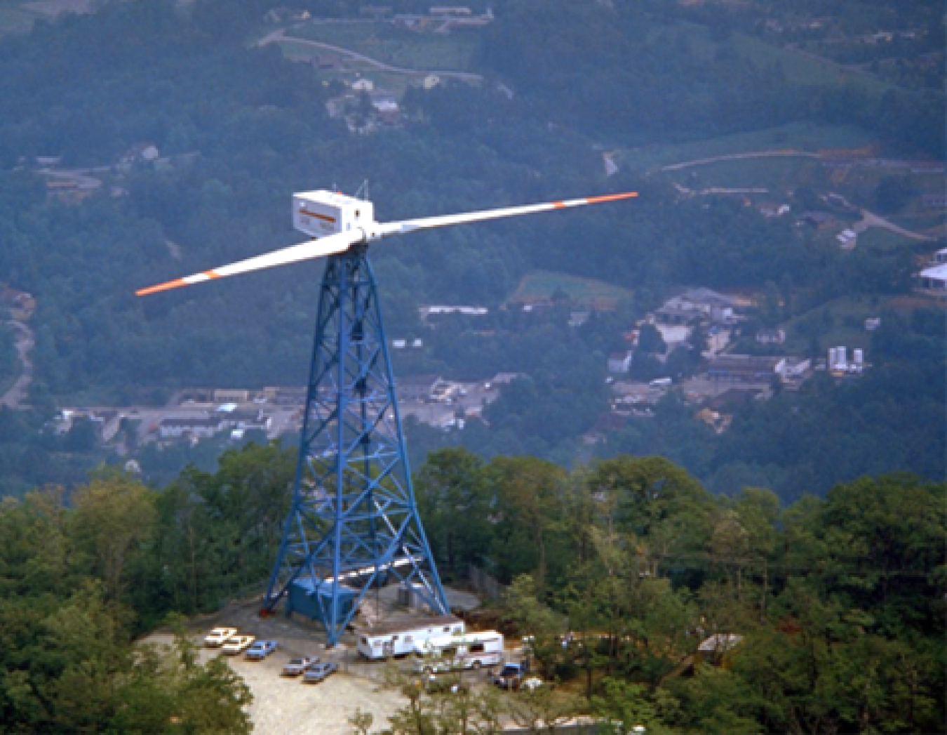 An early wind turbine prototype on top of a hill.