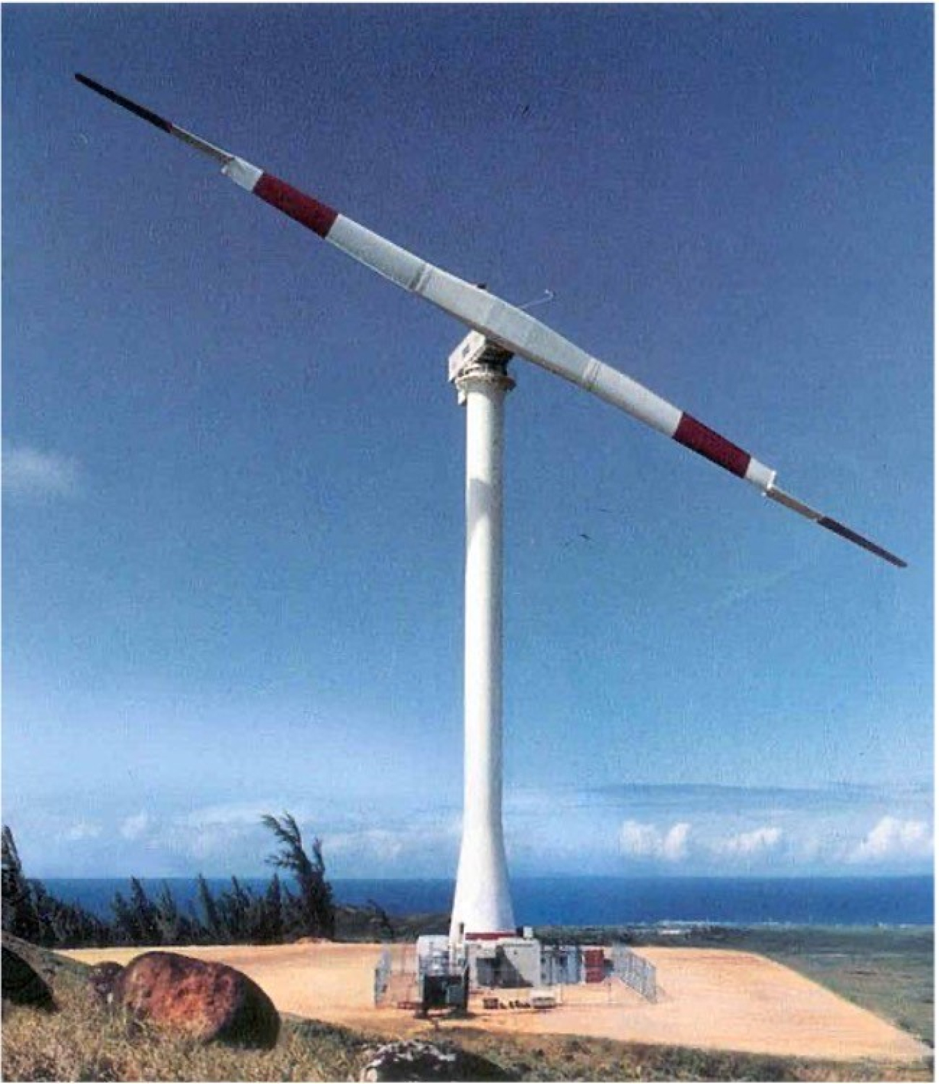 An early wind turbine prototype on a coast.