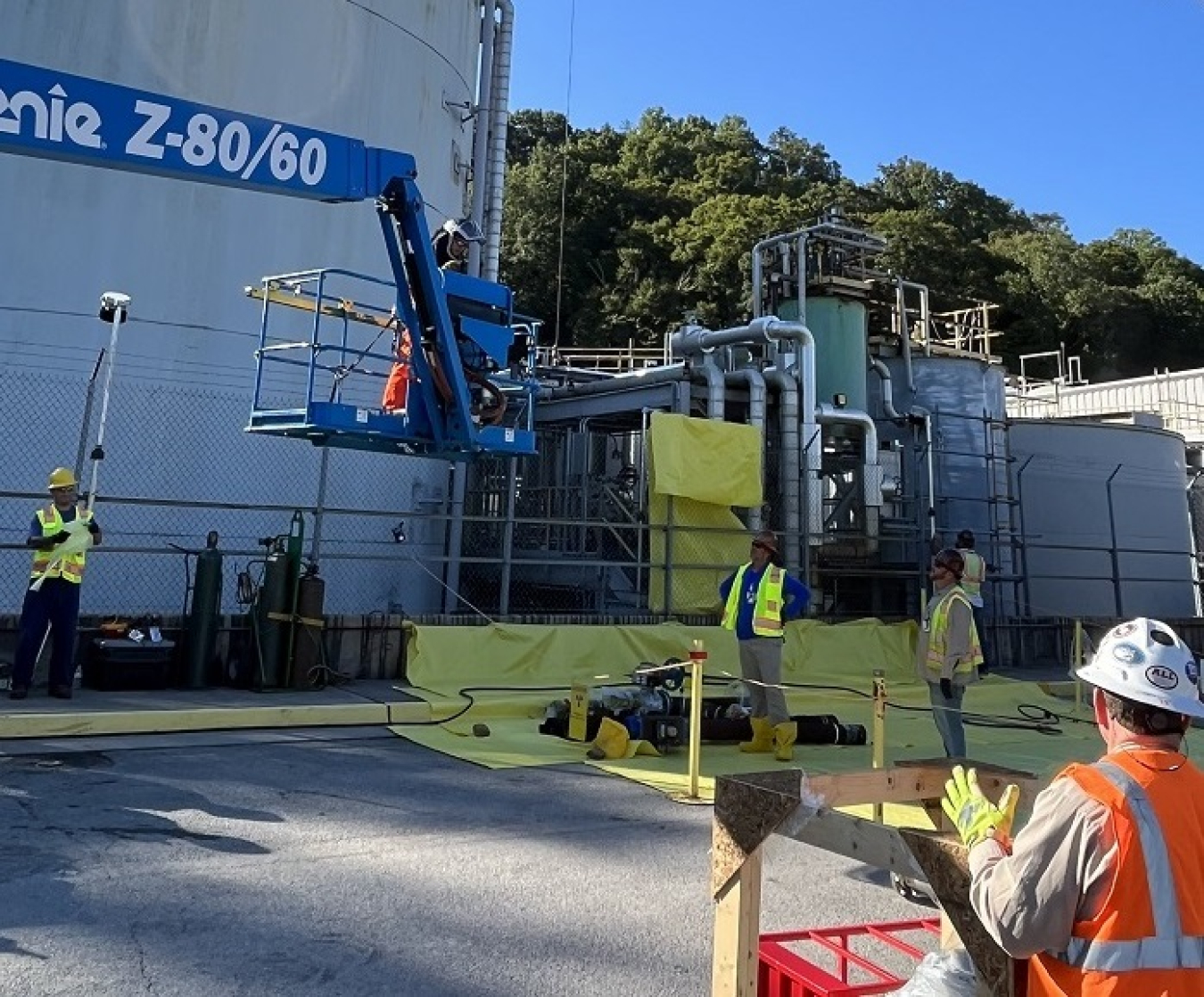 Employees use tools and machinery on site while treating waste