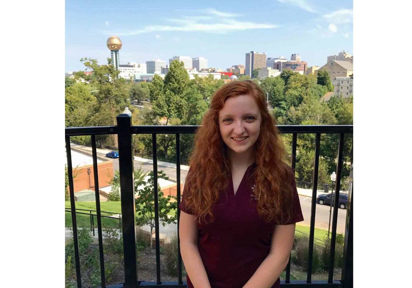 Headshot of Mary Daffron with Knoxville's skyline and Sunsphere in the background