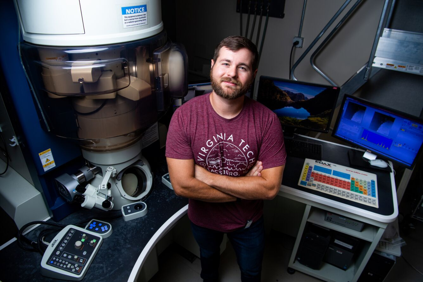 Jacob Haag standing in a lab setting with arms crossed, looking up at the camera.