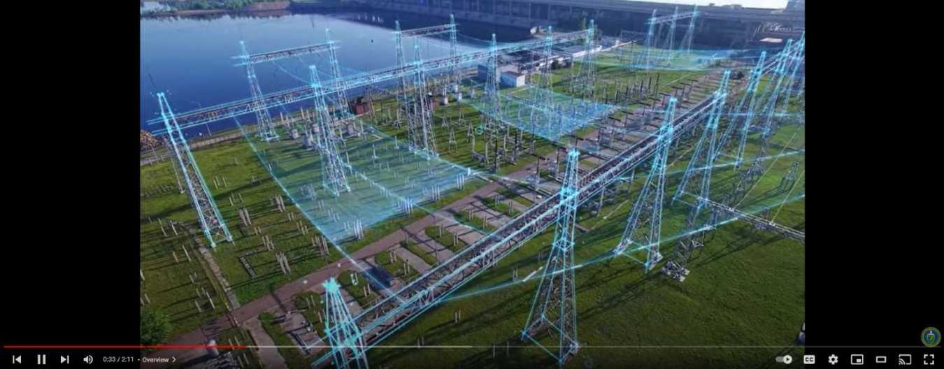 Screenshot of video showing transmission towers with blue line overlays.