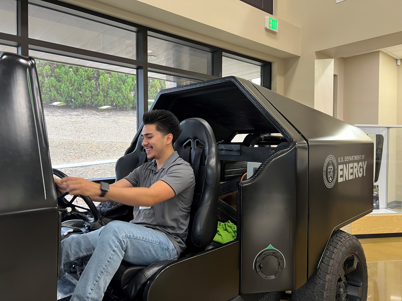 Aguirre sitting at the wheel of a new vehicle prototype