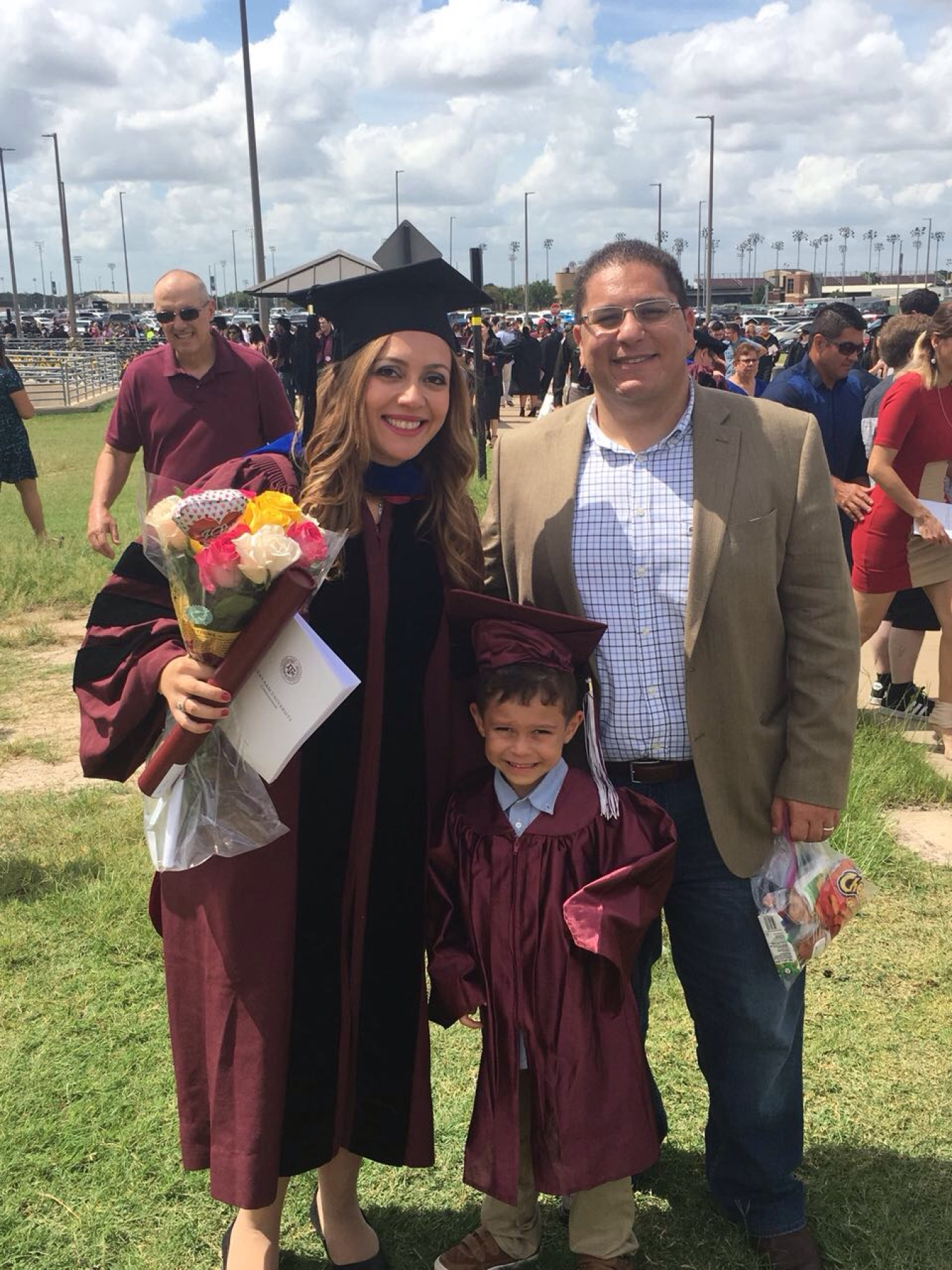 Alaa Elwany with his wife and young son, both of whom are wearing graduation gowns