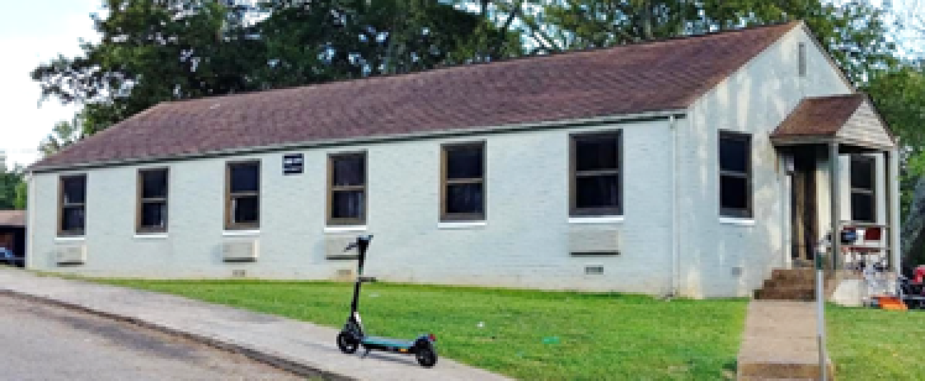 White brick duplex building in a 1940s era style