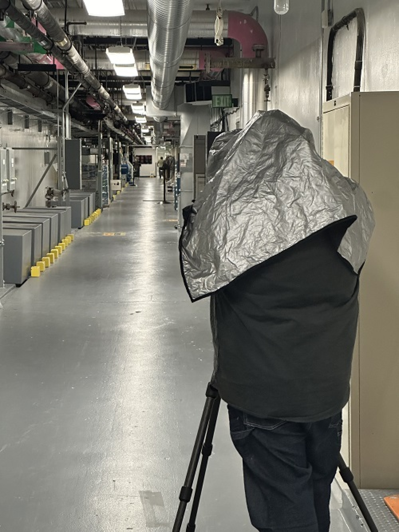 A large camera in a long facility hallway