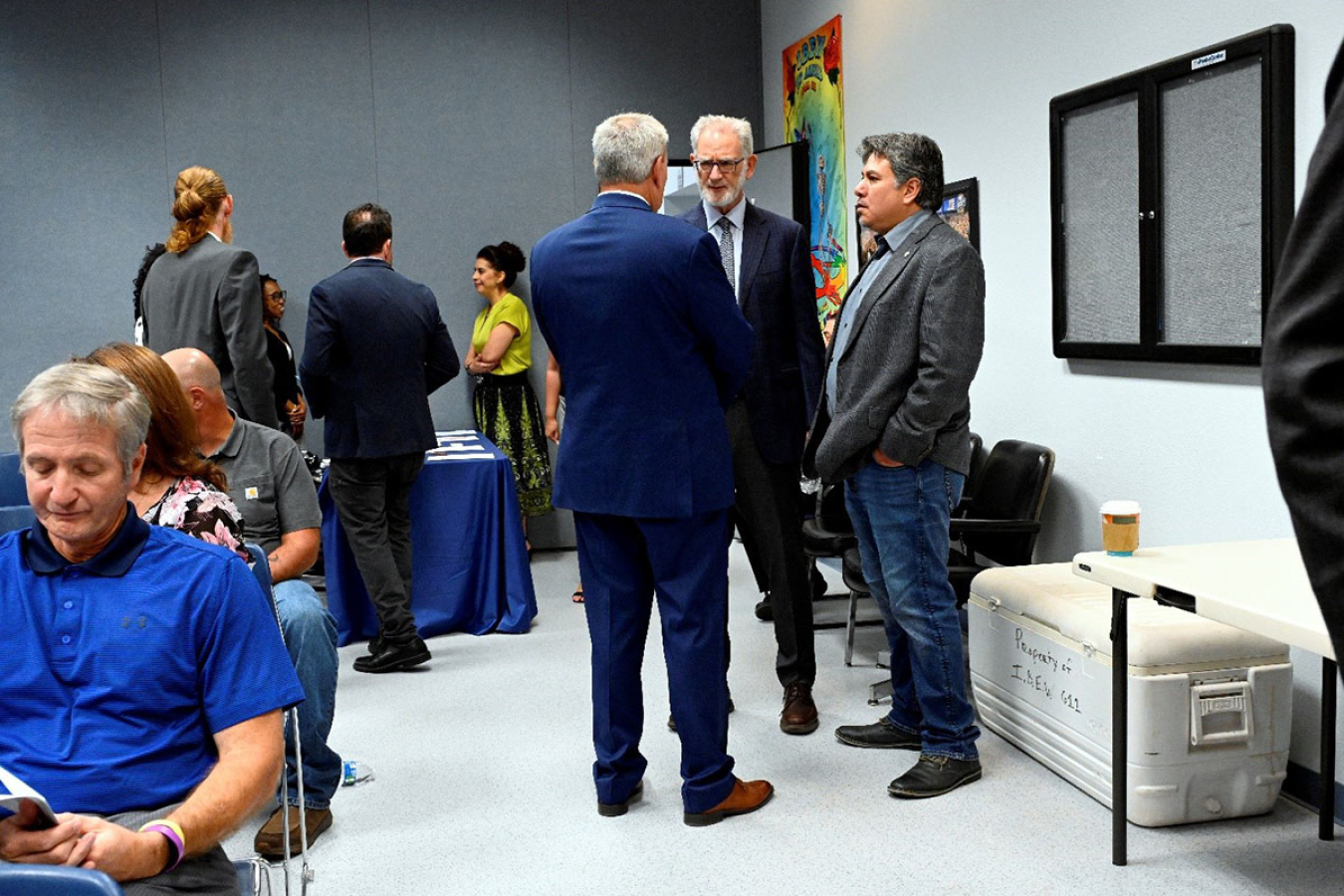 People assemble in a conference room on day one of the event. Mr. Lapointe is in attendance.