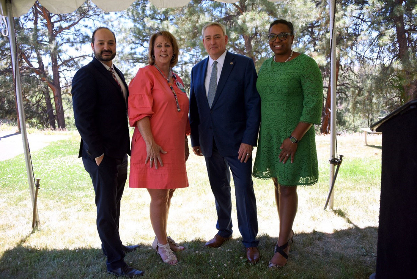 Eric Chavez, Office of U.S. Senator Lujan; our host Tracie Stratton, CEO, Los Alamos Medical Center, Todd Lapointe, Director, DOE’s Office of Environment, Health, Safety and Security, and Shelly-Ann Sinclair. They are under a tent set up on a lawn.