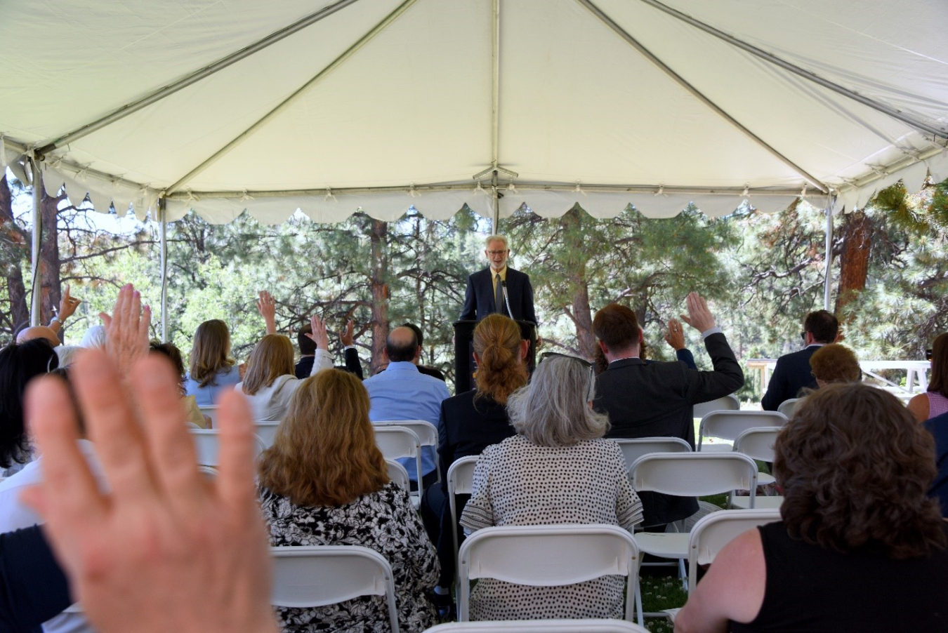 The audience raising their hands under a tent on day 2 of the event. The question they were asked was "Who has, or knows someone with lung cancer?" Dr. Steven Markowitz, Co-Director, the Worker Health Protection Program