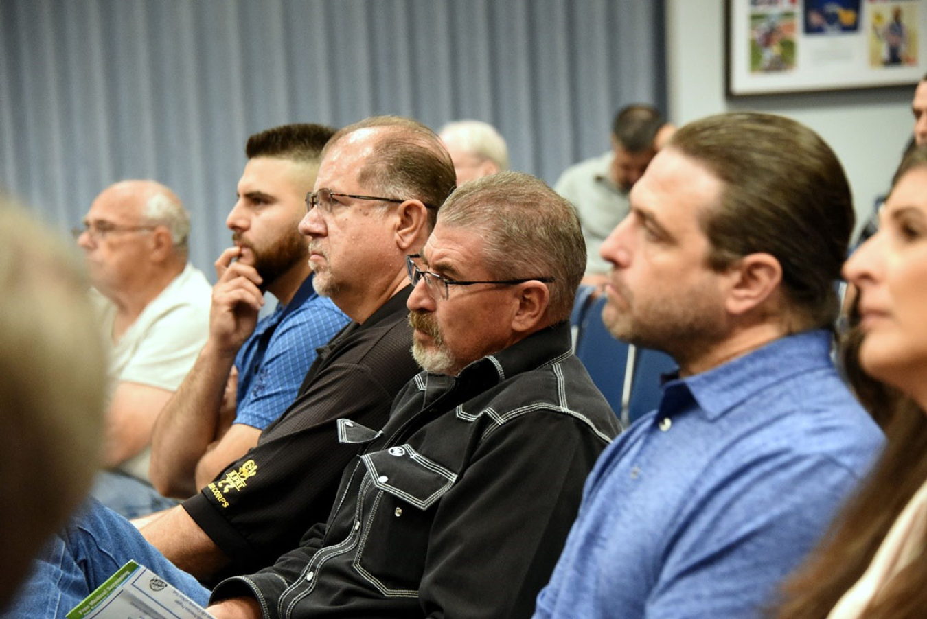 Former workers in attendance listen to the presentations.