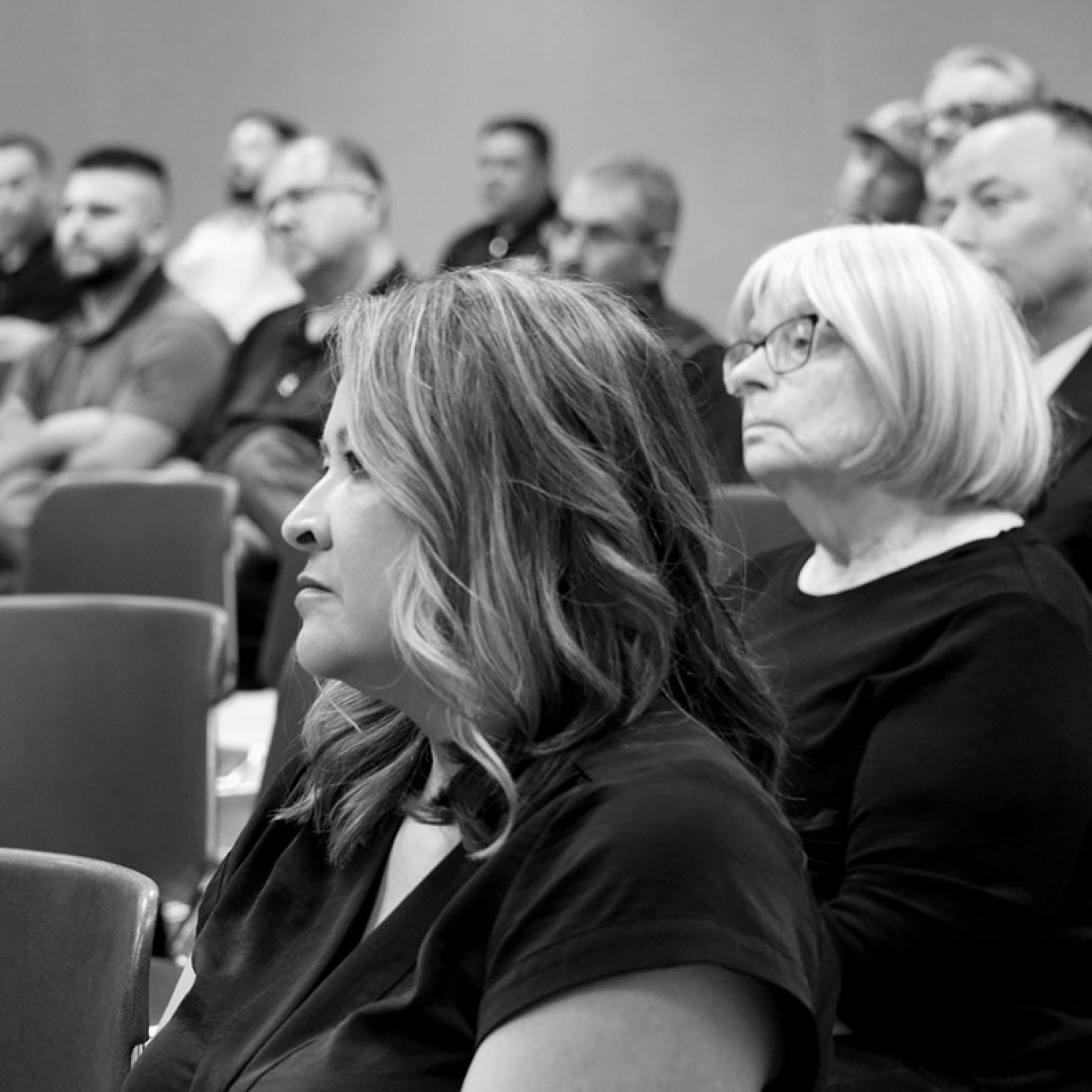 Department of Energy employee Ms. Griego listens to presentations in the audience.