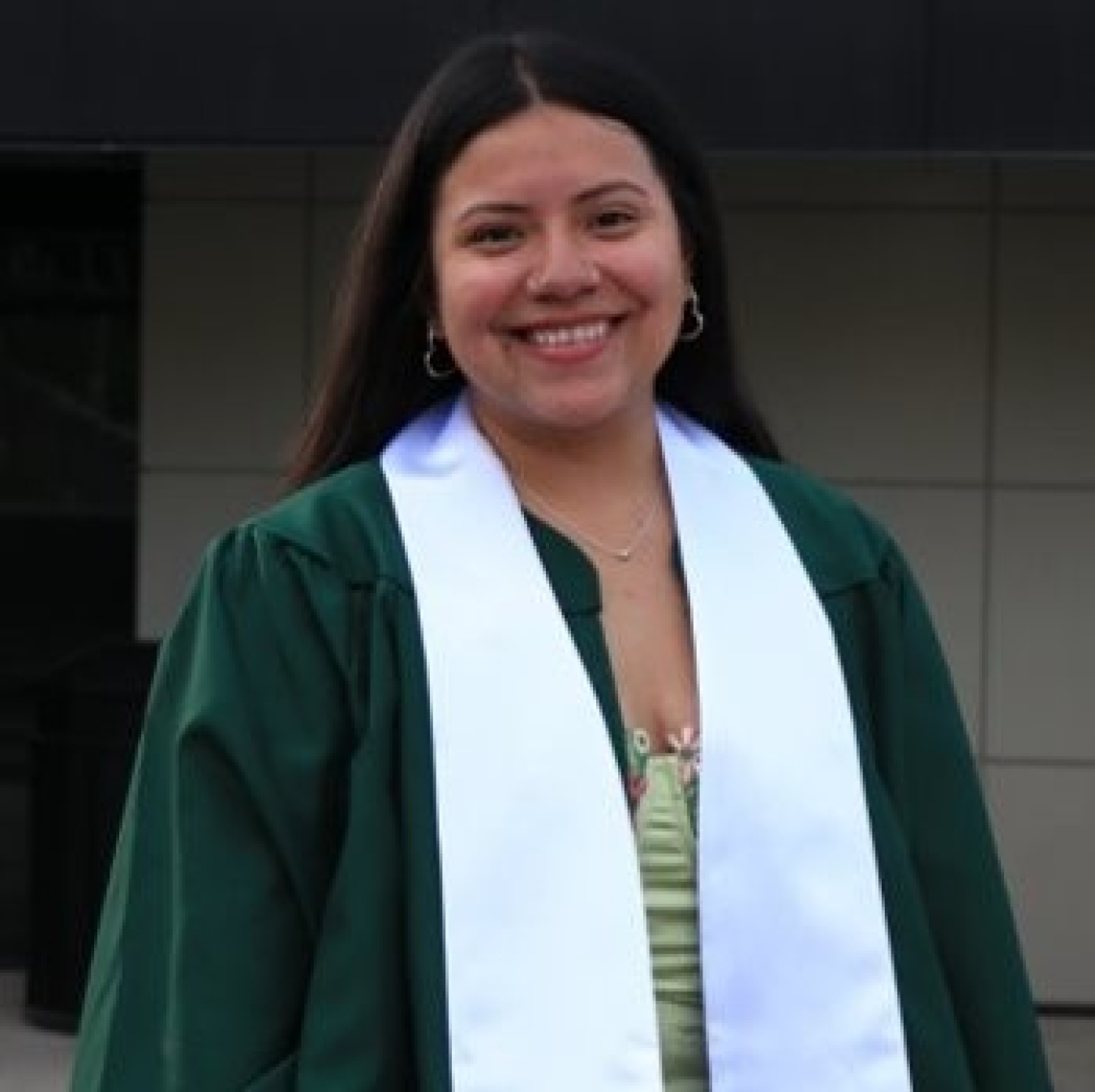 Cecillia Villegas in a graduation gown and sash