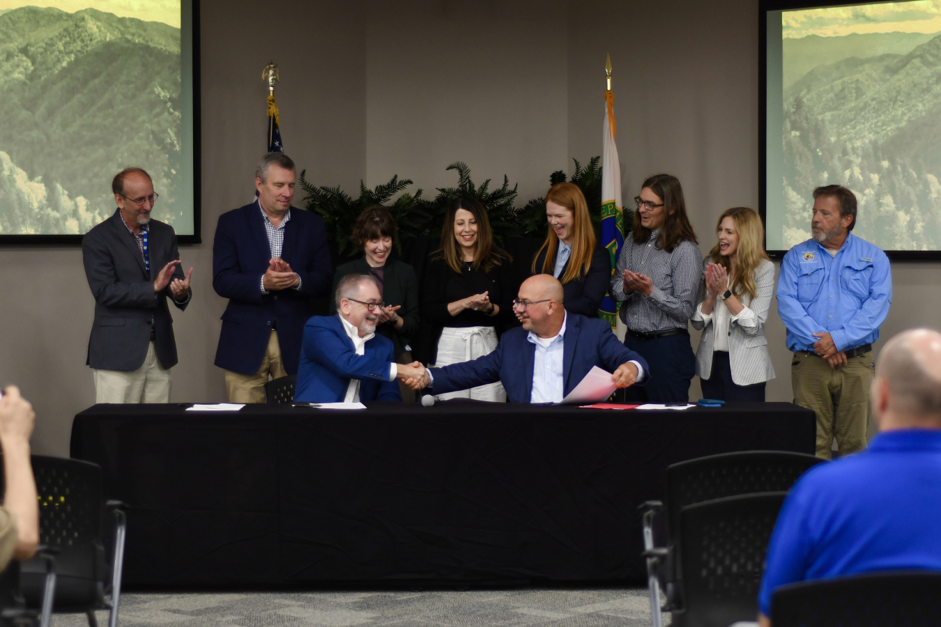 Trustee council members celebrate signing NRDA