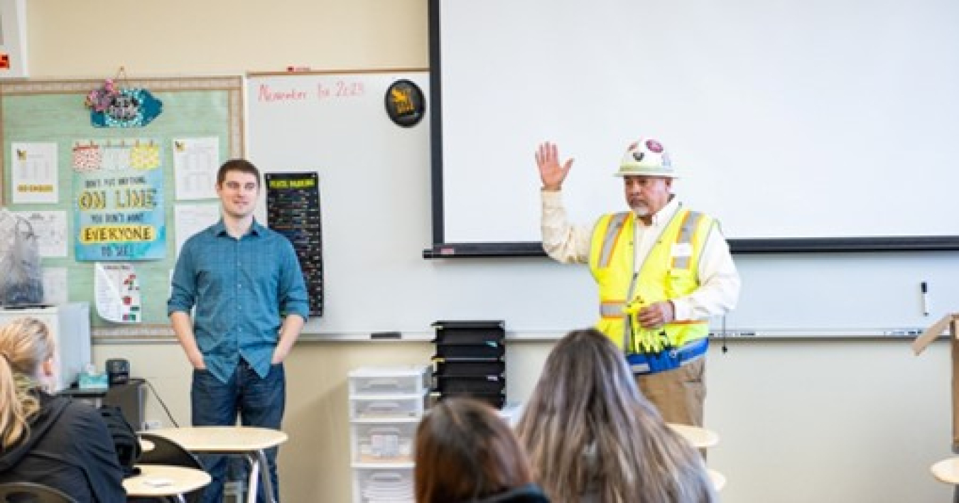 Justin Carpenter and Ed Garza giving a presentation to a classroom.